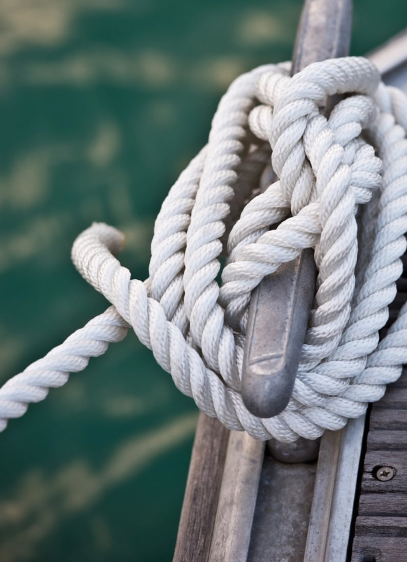 White rope tied on a boat cleat.