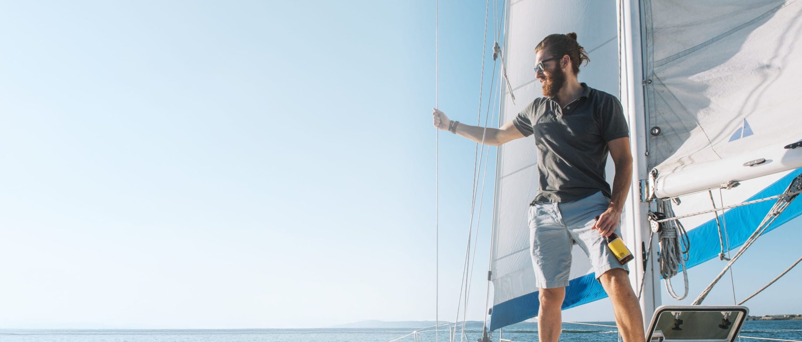 Man sailing on a boat with a drink