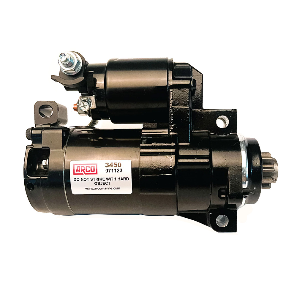 Black motor starter with label and warning.