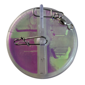 Circular fishing lure with metal clips, pink-green hue.