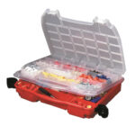 Open red tool organizer with compartments and supplies.