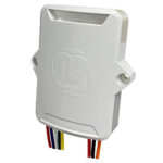 White electronic device with colorful wires protruding.