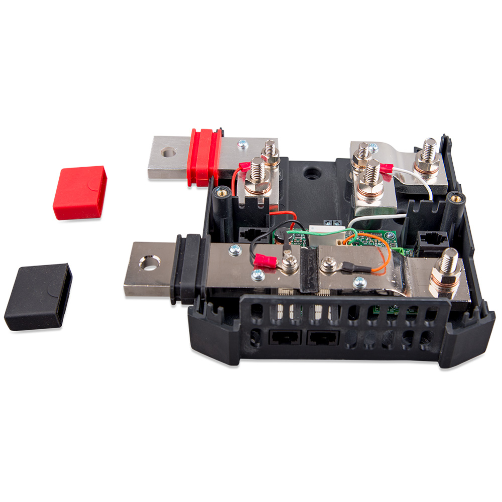 Electrical fuse box components with red, black covers.