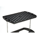 Black hexagonal mesh plastic shelf with metal supports.