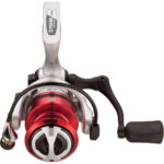 Red and silver fishing reel with black handle.