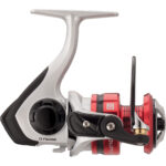 Silver and red fishing reel, side view.
