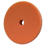 Orange foam polishing pad with central hole.