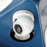White security camera on blue surface