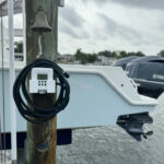 Boat dock post with bell and cable