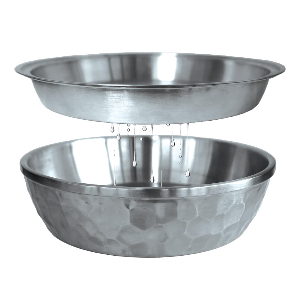 Water dripping between two stainless steel bowls.
