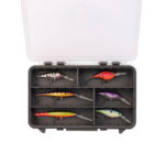Fishing lures organized in tackle box compartments.