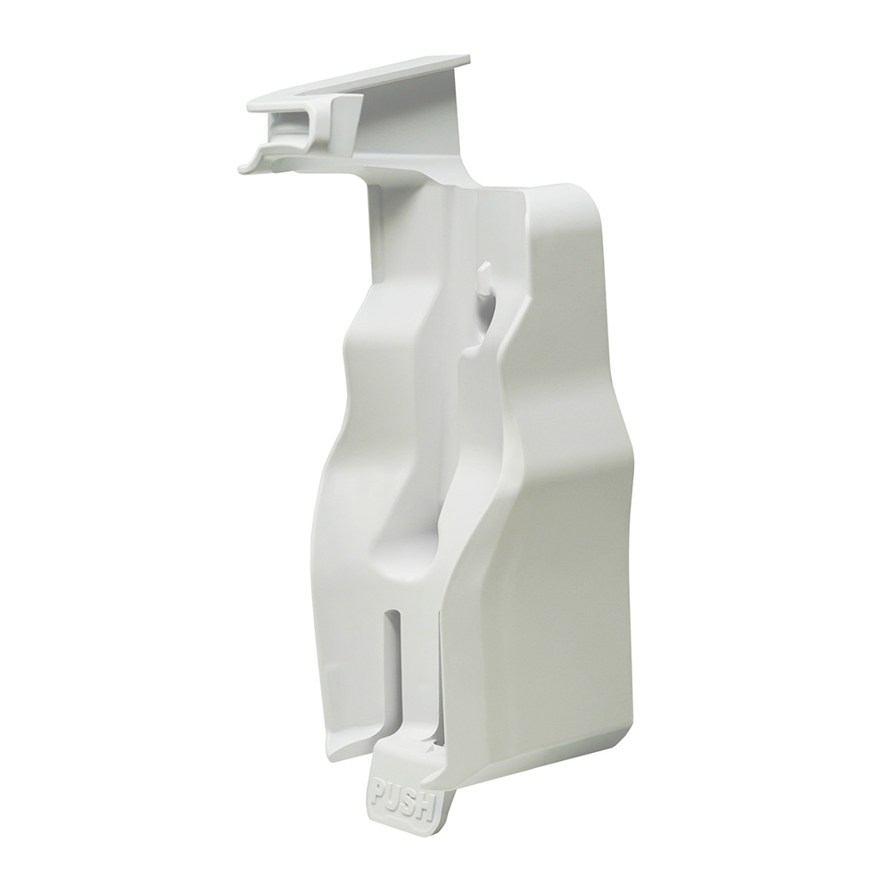 White plastic device component with push mechanism.