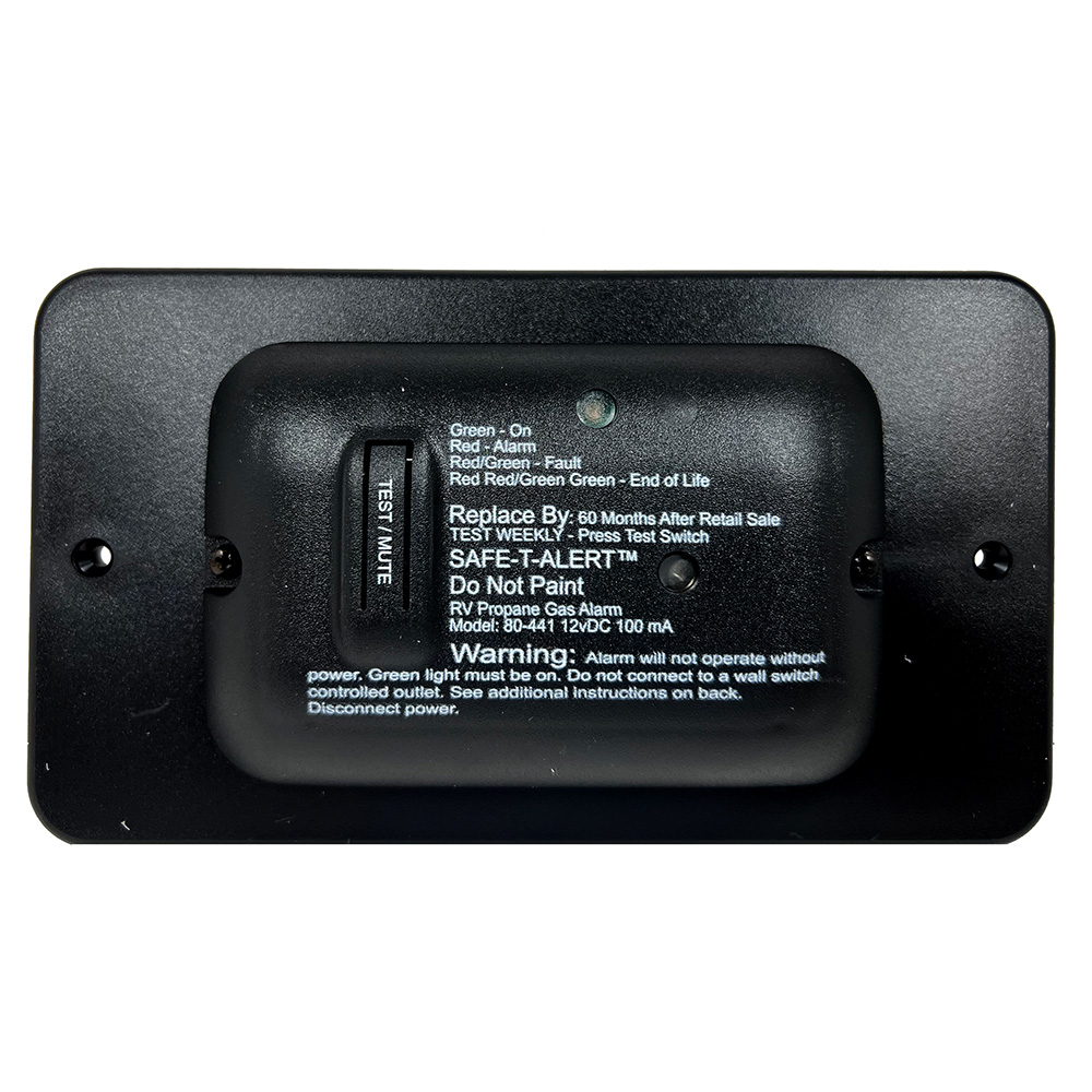 RV propane gas alarm with warning labels.