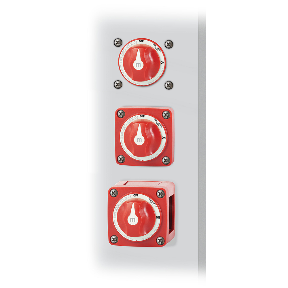 Three red industrial rotary switches on panel