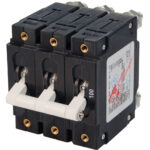 Three-pole circuit breaker with white switches.