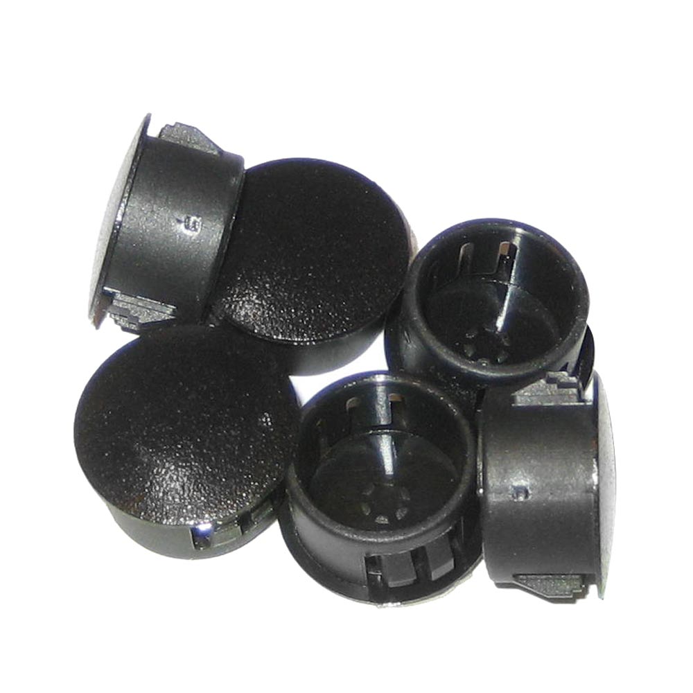 Black plastic hole plugs on white background