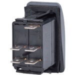 Black electrical rocker switch with metal terminals.