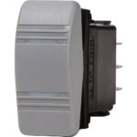 Gray electrical rocker switch, side view.