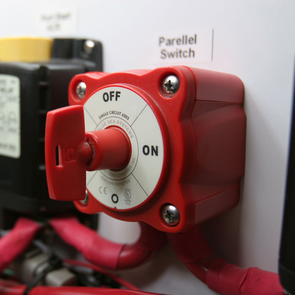 Red switch in off position with cables attached.