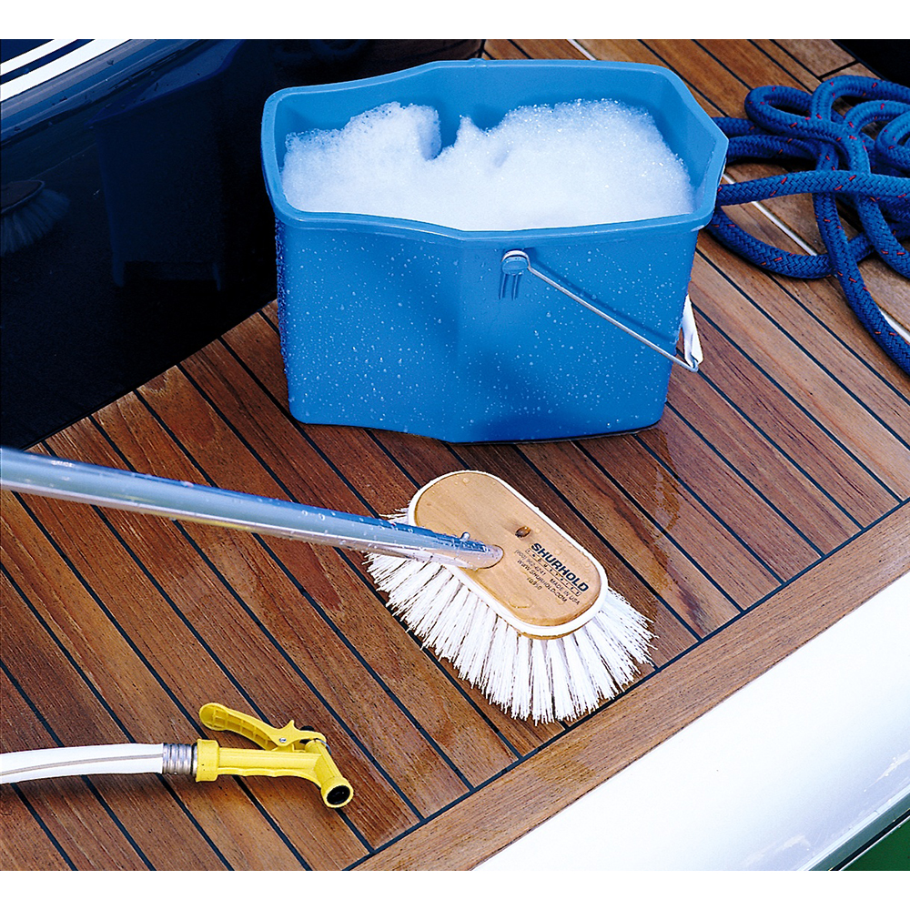 Cleaning supplies on boat deck with soapy water.
