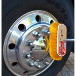 Cleaning chrome truck wheel with yellow brush
