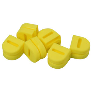 Yellow letter D magnets arranged on white background.
