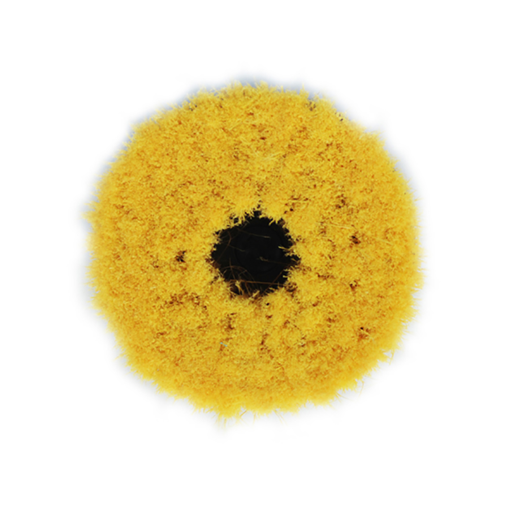 Textured yellow circular object with central hole.