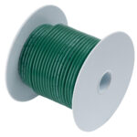 Green electrical wire spool on white background.