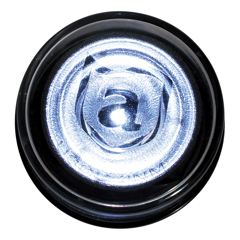 Close-up of translucent bottle cap with letter 'a'.