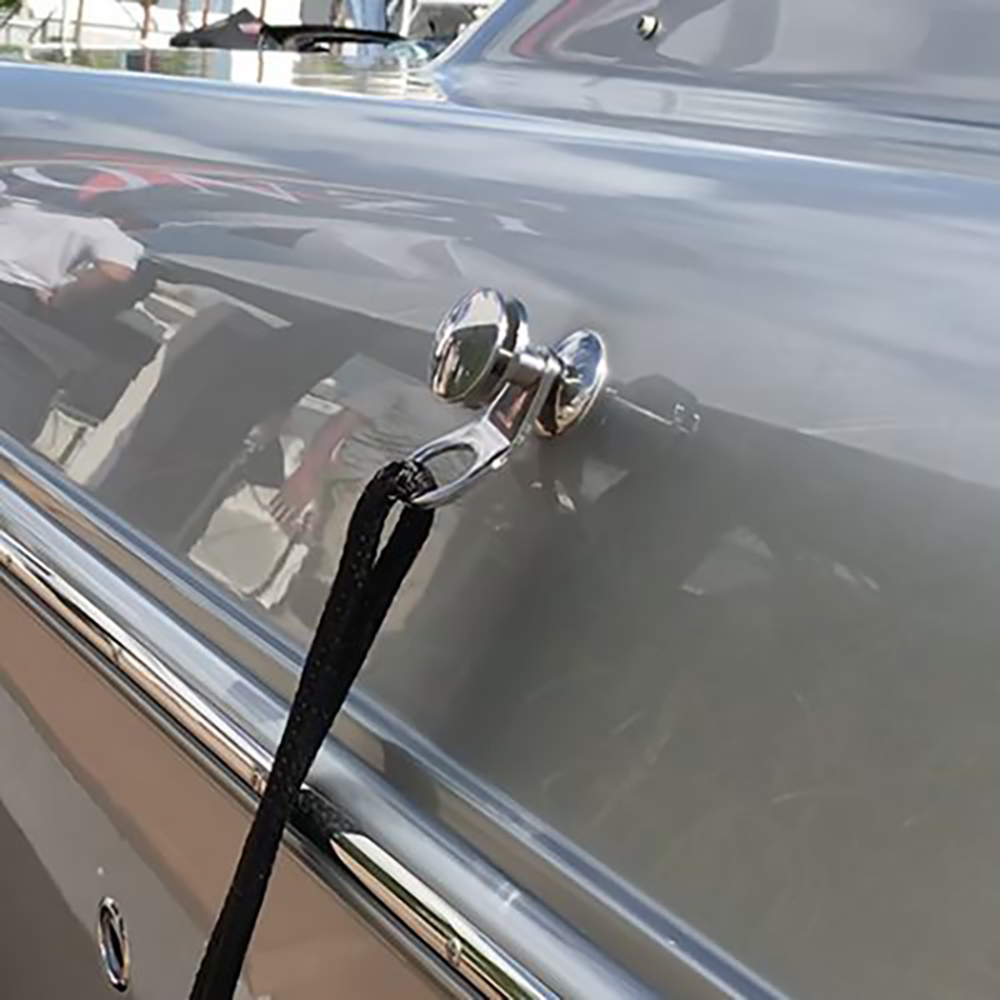 Chrome boat cleat securing black rope
