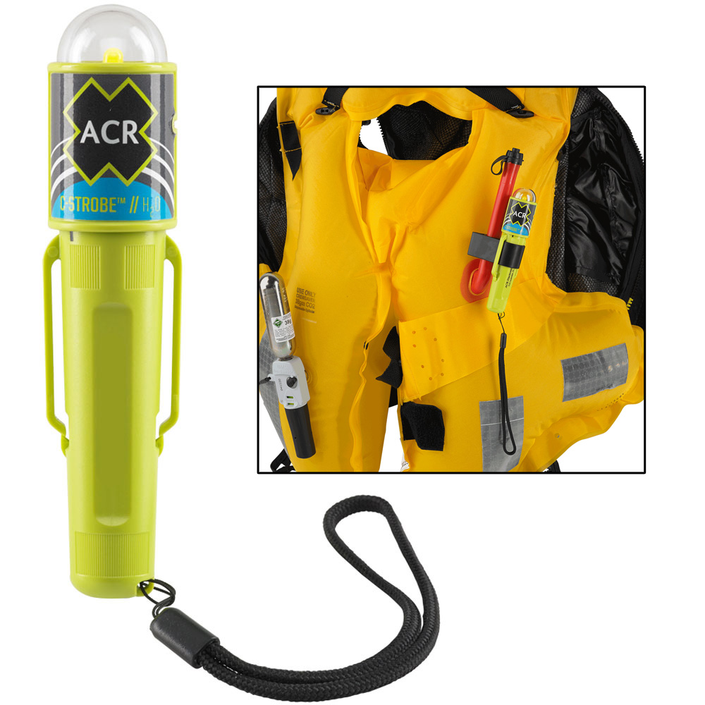 Safety strobe light clipped to yellow life jacket.