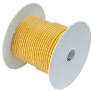 Yellow electrical wire spool on white background