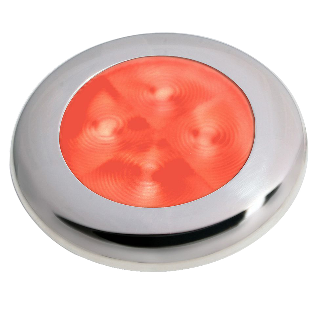 Round metal emergency stop button, glowing red center.