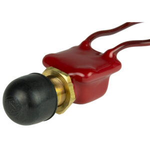 Red push button switch with brass and rubber parts.