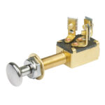 Push-pull switch with brass body in close-up view.