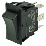 Black rocker switch with metal terminals, close-up view.