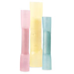 Colored electrical crimp connectors on white background.