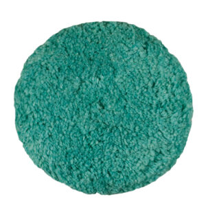 Round teal textured carpet close-up view.