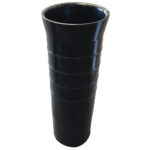 Tall black ribbed vase on white background.