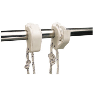 Boat cleats holding ropes on rail