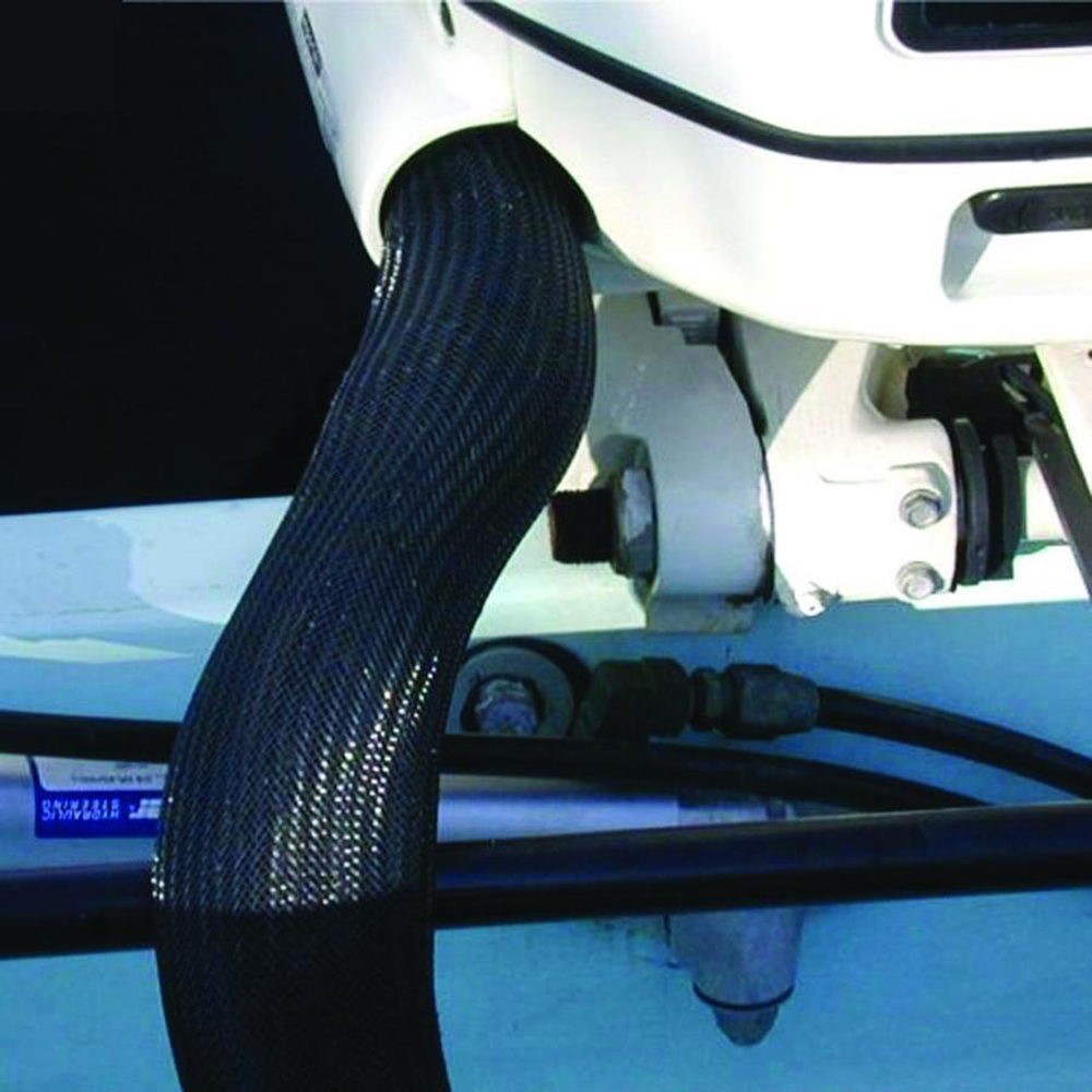 Marine engine cables protected by mesh covering.