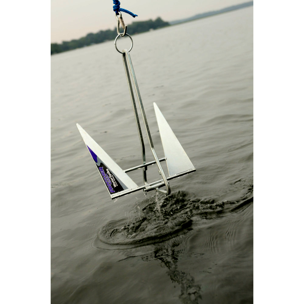 Navy anchor lowering into water.