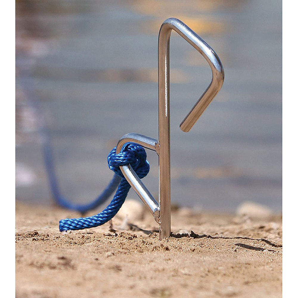 Metal stake with blue rope on beach.