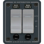 Dual bilge pump control panel with switches and fuses.
