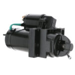 Black automotive starter motor with green wire connection.