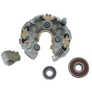 Automotive alternator rectifier and bearings on white background.