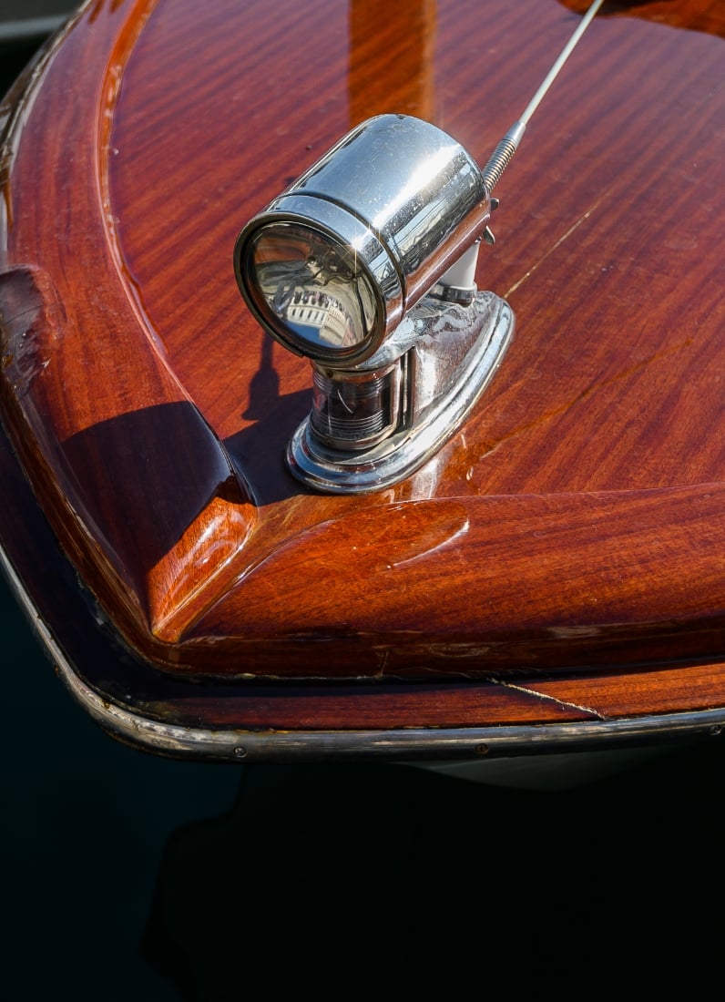 Close-up of vintage wooden boat bow light.