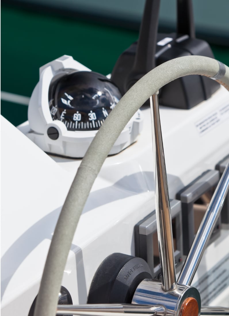 Boat steering wheel and compass close-up