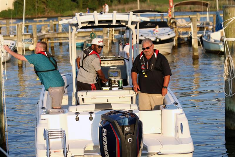 Men on a boat docked at marina.