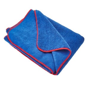 Folded blue microfiber cleaning cloth with red trim